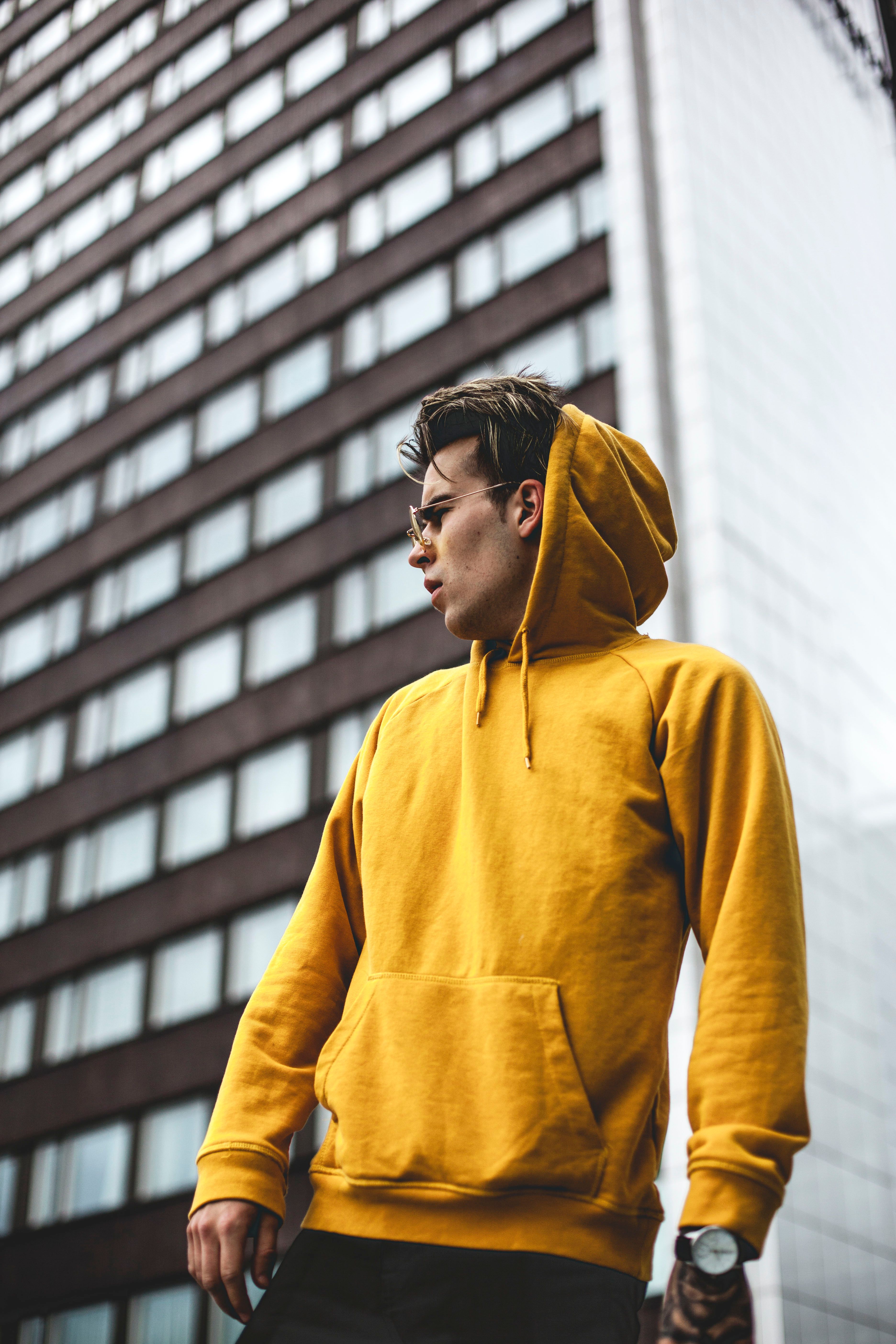 Streetwear model wearing oversized hoodie and cap in urban setting